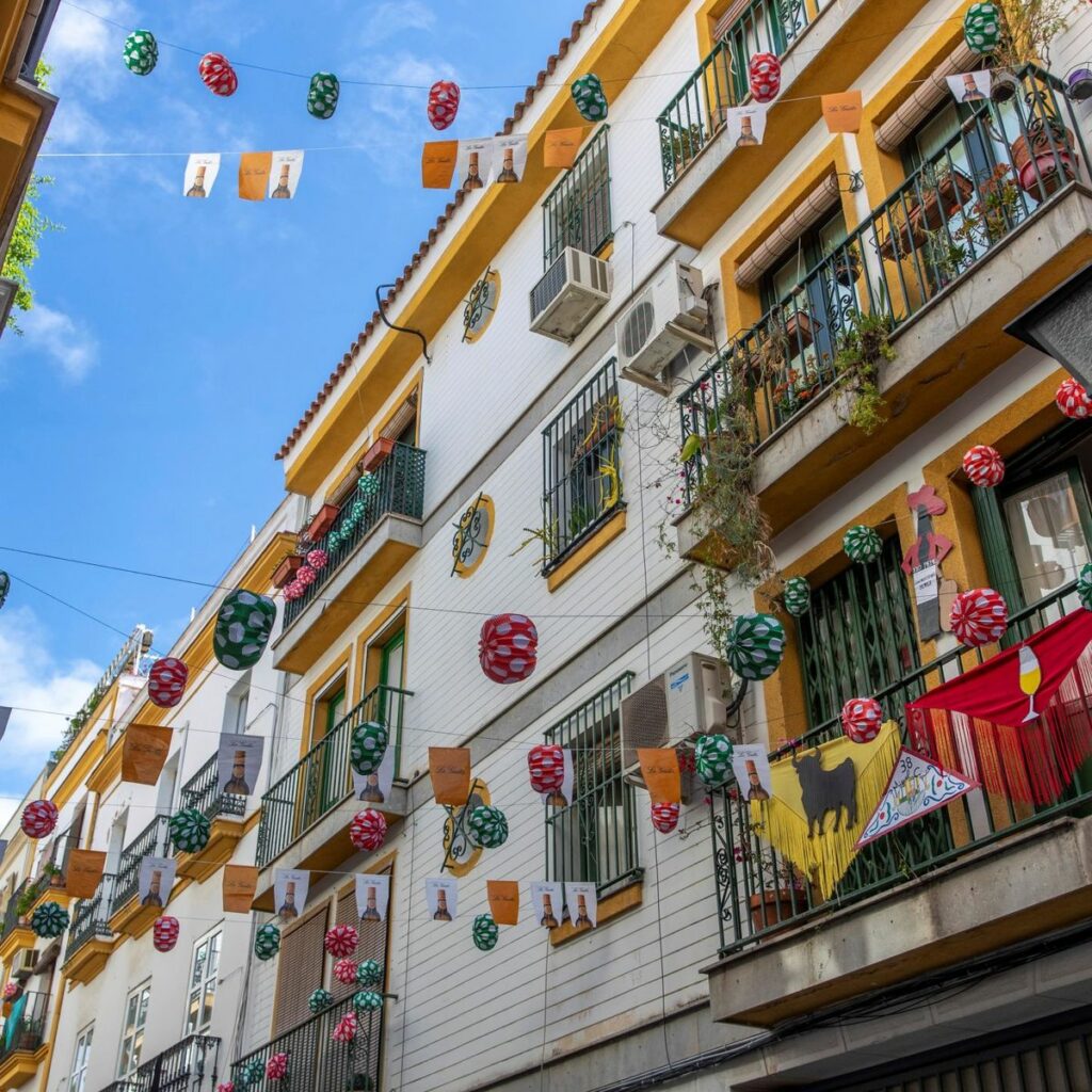 Andalusian balcony adorned with colorful flowers and festive lights